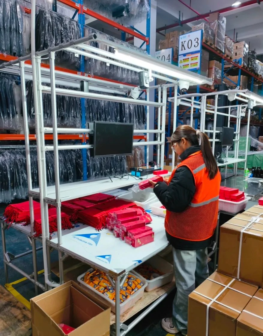 A team member preparing products at a warehouse fulfillment workstation