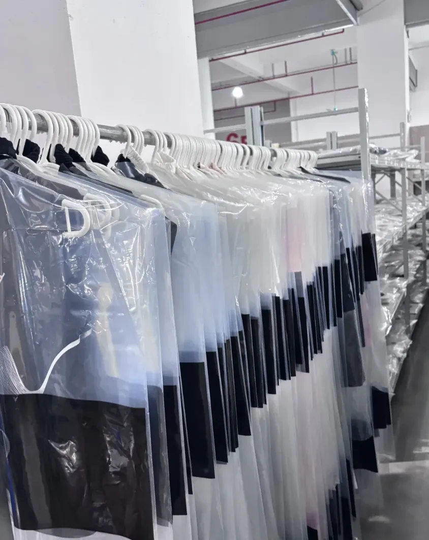 Garments held on rails in a warehouse stock area