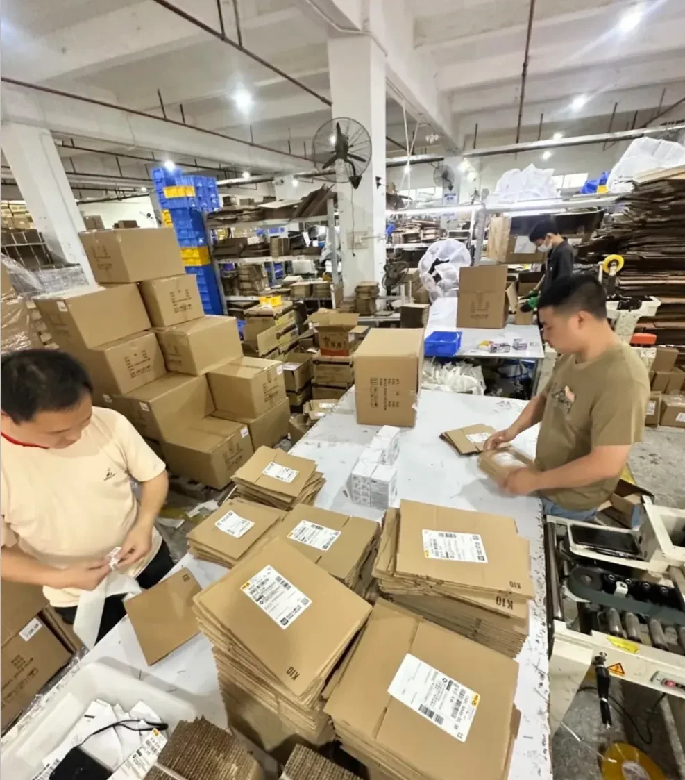 Team members handling incoming cartons at warehouse tables