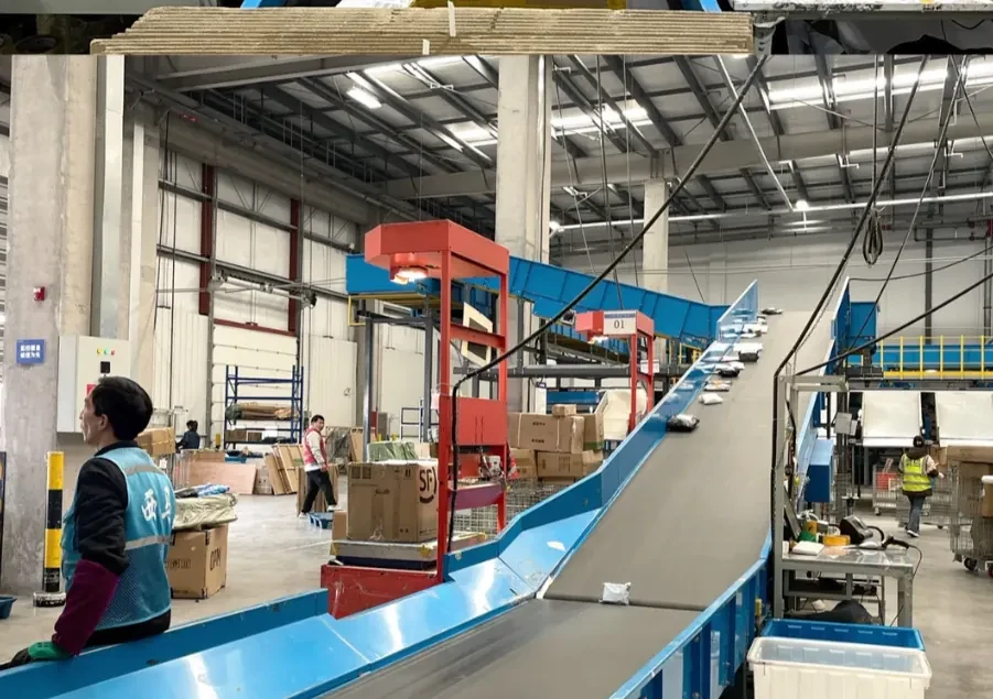 Cartons moving through a warehouse receiving conveyor