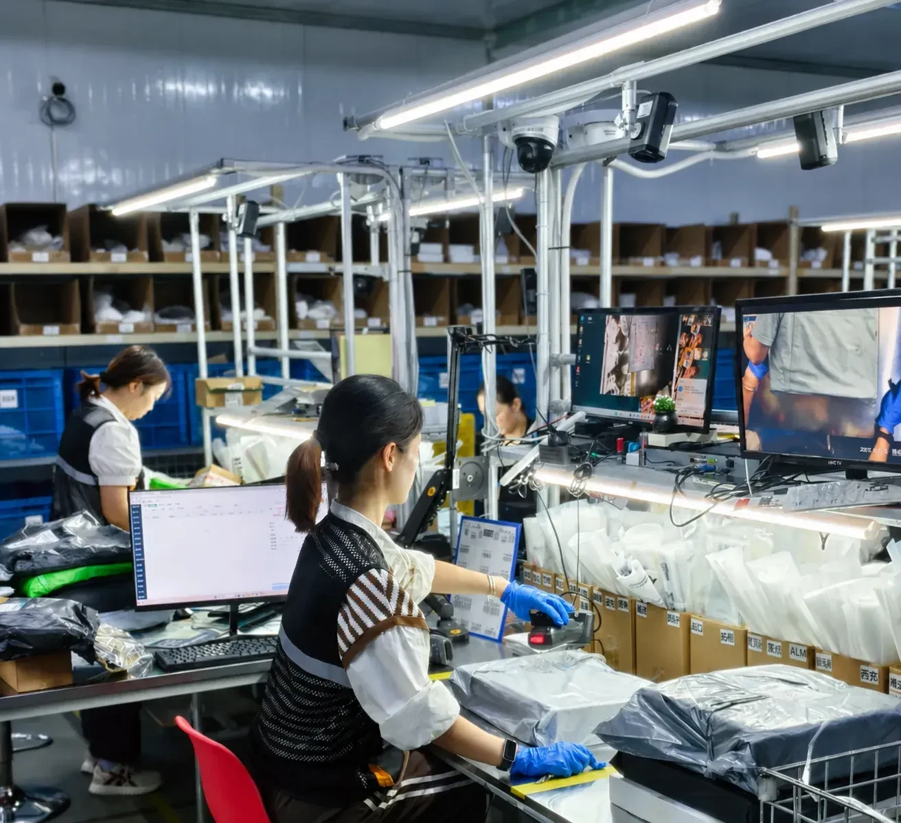 Team members checking products at a warehouse workstation