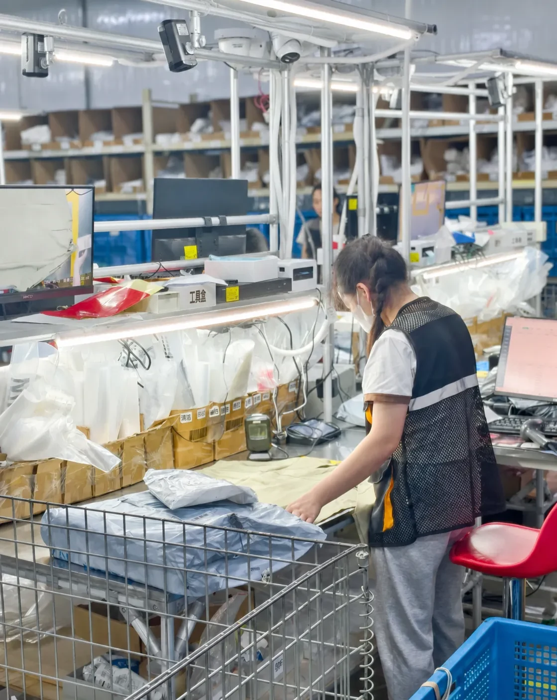 A team member checking items beside warehouse stock bins