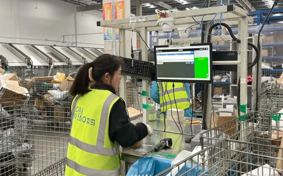 A team member processing a parcel at a warehouse weighing station