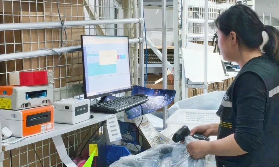 A team member registering a parcel at a warehouse terminal